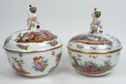 A graduated pair of ornate German hand-painted&nbsp;porcelain lidded tureens with Bacchanalian&nbsp;cupid finials, 19th/20th&nbsp;century, blue factory mark to base, 34cm and 33cm high - 2