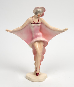 A Continental Art Deco porcelain statue of a dancing lady in a pink frock, 26.5cm high