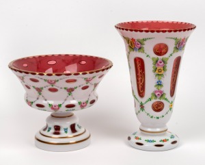 A Bohemian ruby overlay glass vase with enamel floral decoration; together with a matching mantle urn, 20th century, (2 items), 23.5cm and 16cm high