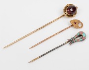 Three assorted antique tiepins, two examples in gold and one in silver enamel, 19th/20th century, the largest 8cm high