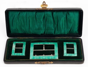 A set of three antique sterling silver and green enamel shoe and belt buckles, housed in original plush fitted case, the case 15.5cm wide.