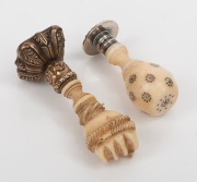 Two antique carved ivory seals, one with inlaid cut steel, the other handsomely carved in the form of a fist, 18th/19th century, 4cm and 5cm high. - 2