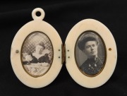 An antique carved ivory photo locket housing two black and white portraits, 19th century, 5.5cm high