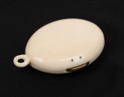 An antique carved ivory photo locket housing two black and white portraits, 19th century, 5.5cm high - 2