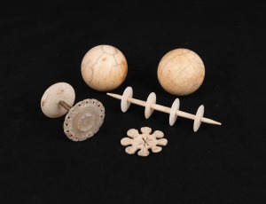 Two antique ivory bagatelle balls; together with three ivory and mother of pearl implements, 19th century, (5 items), the largest 9cm wide