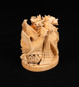 A Chinese carved ivory figure group of phoenix birds and flowers executed in the Ming style, early to mid 20th century, seal mark to base, 8.5cm high