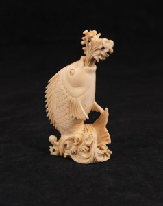 An antique Chinese carved ivory leaping fish snuff bottle, 19th/20th century, 9cm high