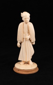 A Burmese carved ivory statue of a young man mounted on timber base, 19th/20th century, ​​​​​​​15.5cm high overall