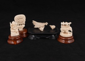 Three Indian carved ivory ornaments on turned wooden stands; together with a Japanese carved ivory figure group of birds on wooden stand, A/F, (4 items), ​​​​​​​the largest 7cm high overall