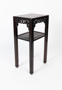 An antique Chinese solid rosewood occasional table with rectangular panel top, scroll pierced carved apron and lower shelf, circa 1910, 79cm high, 41cm wide, 30cm deep