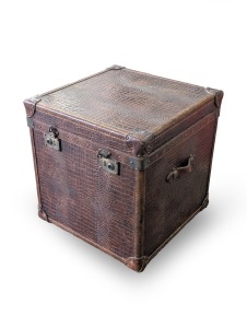 A vintage travelling lift-top trunk with carry handles and brass locks stamped "Bond Street, London", 59cm high, 59cm wide, 59cm deep