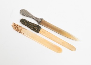 Three antique paper knives comprising of one with silver handle and horn blade, one carved bone and the other pressed metal and bone, 19th/20th century, the largest 22.5cm long