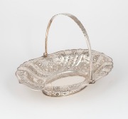 An antique English sterling silver pierced bread basket, made by Atkin Brothers of Sheffield, circa 1893, 22cm high including handle, 31cm wide, 546 grams