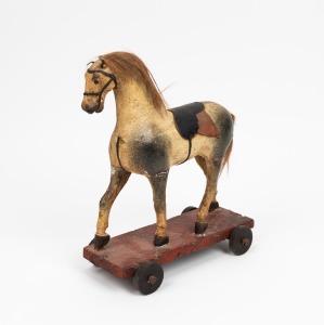 An antique pull-along horse toy, carved wood with painted gesso finish,&nbsp;19th century, 31cm high