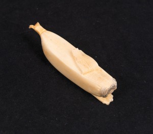 An antique Japanese carved whalebone banana, Meiji Period, 19th/20th century, 12cm long