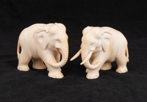 A pair of carved ivory elephant statues, 19th/20th century. Note: One example missing tusks. ​​​​​​​8cm high, 10cm long.