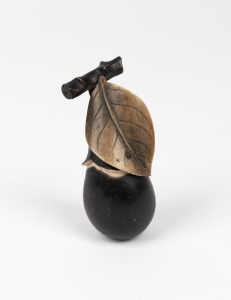 A Chinese carved ivory aubergine ornament with black painted finish, early to mid 20th century, 8cm long