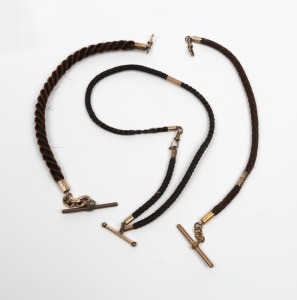 Three antique braided hair fob chains with 9ct gold and gold plated mounts, 19th century, the largest 40cm long.