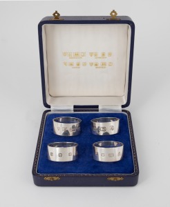 A boxed set of four English sterling silver napkin rings, attractively displayed with explanatory gilt inscriptions, 122 grams total