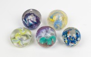 Five assorted glass paperweights, 20th century, the largest 7cm high, 8cm diameter.