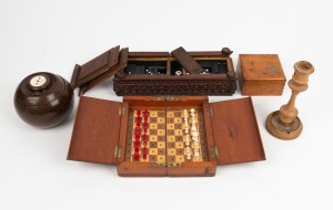 Carved timber games box with compartment drawers to base and gaming pieces; together with a souvenir of Jerusalem olive wood candlestick, a New Zealand timber box with paua shell kiwi inlay, a lignum vitae antique lawn bowl converted to a tobacco jar and 