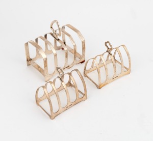 110 · Three antique sterling silver toast racks, all made in Sheffield, circa 1908, ​​​​​​​the larger 10cm high, 220 grams total.