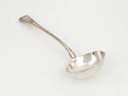 A Georgian sterling silver soup ladle with shell decoration and engraved family crest, made in London, circa 1816, 33cm long, 280 grams