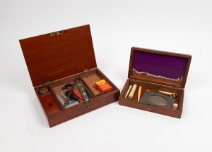Two antique English mahogany boxes, housing an assorted collection of novelty miniature tools, whalebone bodkins, pen knives, thimble etc., 19th and 20th century, ​​​​​​​the larger box 25cm wide