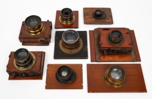 Group of eight brass lenses, three of which with roller-blind shutter, all mounted on lens boards, from manufacturers such as Taylor Taylor & Hobson and Beck. (8 items)