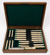 A set of 12 antique bone handled knives in two sizes, each adorned with engraved monogram, housed in a fitted oak canteen, 19th century, ​​​​​​​the canteen 35.5cm wide.