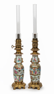 A pair of Chinese porcelain table lamps with gilt metal fittings and glass chimneys, ​​​​​​​80cm high.
