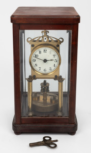 An antique German 400 day anniversary clock with disc rotary pendulum and library four glass case, early 20th century, 31cm high