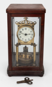 An antique German 400 day anniversary clock with disc rotary pendulum and library four glass case, early 20th century, 31cm high