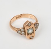 An antique 15ct gold ring, set with an aquamarine, two diamonds and flanked by three seed pearls on each shoulder, circa 1900, stamped "15ct", 4.5 grams total