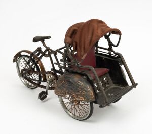 A vintage miniature rickshaw ornament, (working order), 22cm high, 36cm wide