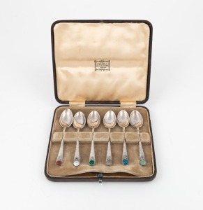A box set of English sterling silver teaspoons in the Arts & Crafts style, adorned with cabochon stones, made in Birmingham, circa 1930, the box 14.5cm wide