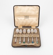 A box set of English sterling silver teaspoons in the Arts & Crafts style, adorned with cabochon stones, made in Birmingham, circa 1930, the box 14.5cm wide