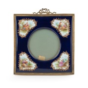 An antique French porcelain picture frame with gilt metal mounts and easel stand, 19th century, 21 x 1.5cm.