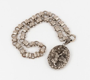 An antique sterling silver oval pendant locket suspended on an attractive antique English sterling silver chain, 19th century, the chain 37cm long