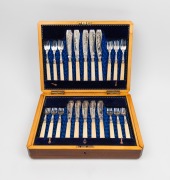 An antique silver plated fish cutlery service with engraved floral decoration and ivory handles, housed in original canteen, (setting for twelve with servers), 19th century, ​​​​​​​the canteen 26cm wide