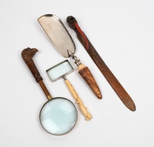Antique crumb tray with ivory handle, magnifying glass with carved ivory handle,&nbsp;magnifying glass with carved wood birds head handle and a wooden paper knife with carved grotesque handle, mixed vintages, (4 items), the largest 36cm long