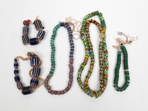 TRADE BEADS: A handsome selection comprising of Venetian and African trade beads displayed as necklaces and strands, (5 items)
