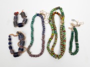 TRADE BEADS:&nbsp; A handsome selection comprising of Venetian and African trade beads displayed as necklaces and strands, (5 items)