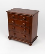 An Australian cedar and pine miniature five drawer apprentice chest with floral marquetry decoration to the top and ownership details "Mrs E. G.", 39cm high, 35cm wide, 22cm deep