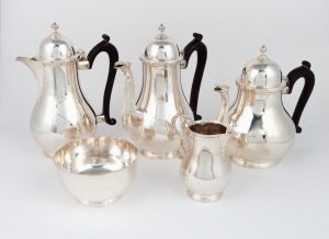 A vintage five piece English sterling silver tea and coffee service in the Georgian style with ebonised timber handles, manufactured in London, 20th century, the largest 22cm high, 2458 grams total (including handles)