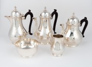 A vintage five piece English sterling silver tea and coffee service in the Georgian style with ebonised timber handles, manufactured in London, 20th century, the largest 22cm high, 2458 grams total (including handles)