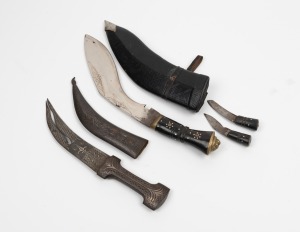 A Nepalese khukuri&nbsp;in scabbard; together with a tribal dagger in metal scabbard with silver inlay, (2 items), the larger 40cm long including scabbard
