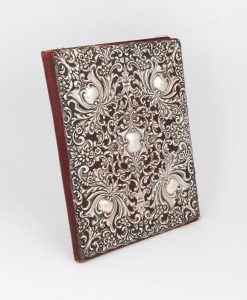 80 · An antique sterling silver covered scarlet leather notebook, interior attractively finished in water wash scarlet silk with two ivory note pages, 19th century, 28 x 21cm overall