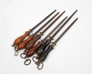 Group of six assorted sharpening steels with turned timber handles, 19th/20th century, ​​​​​​​the largest 45cm long.
