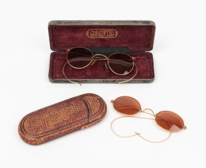 Two pairs of antique spectacles (one in a New Zealand retailer's case), 19th/20th century